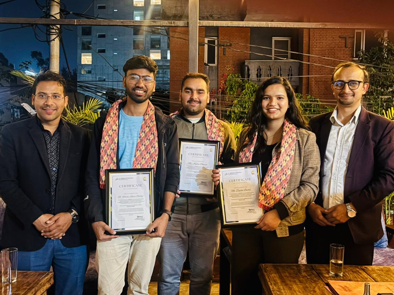 Trainees receiving completion certificates from the firm's partners